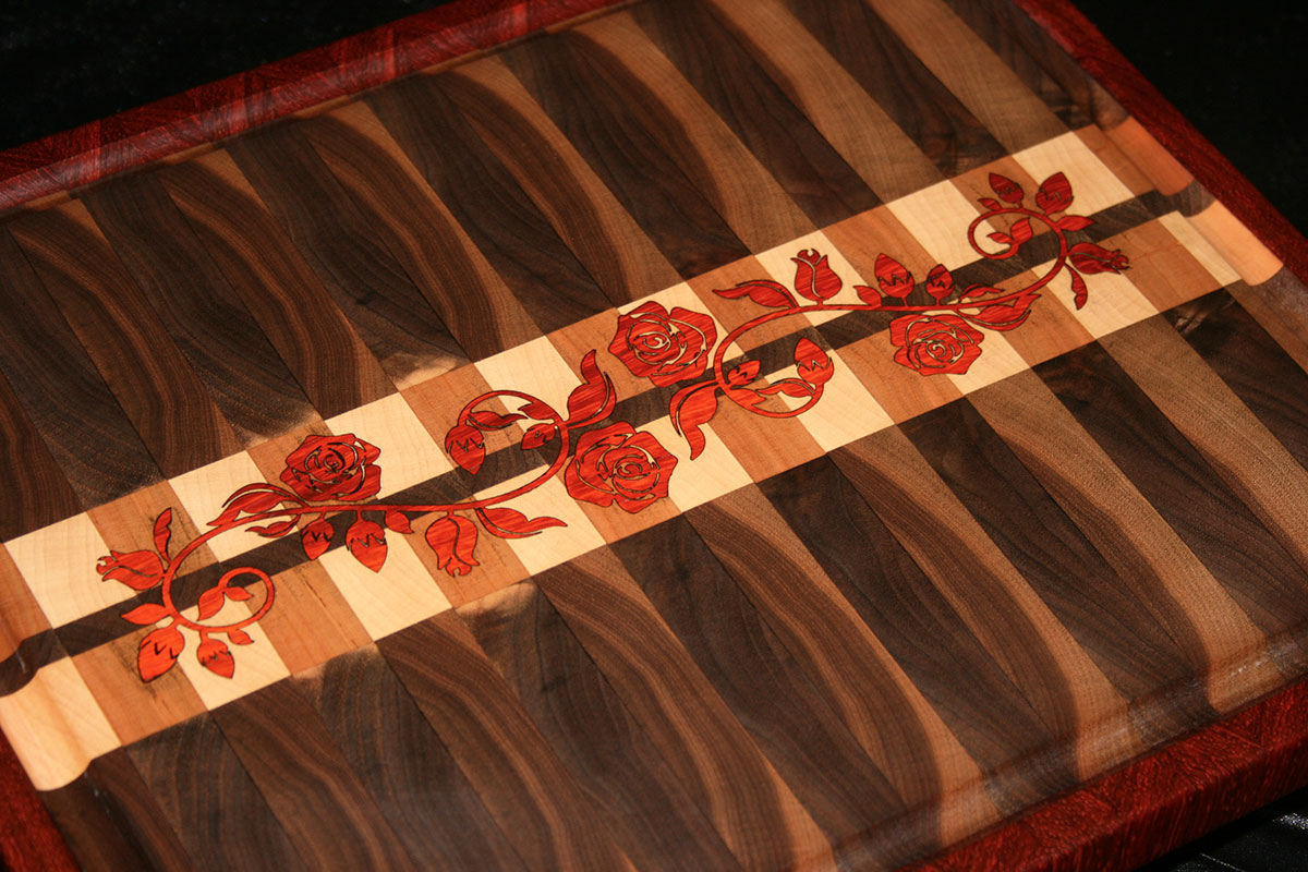 A Walnut Cutting Board with Maple & Cherry Pattern, a Padauk border and inlay.
